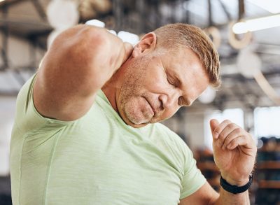 mature man sore at gym, concept of fitness habits that cause muscle fatigue as you age